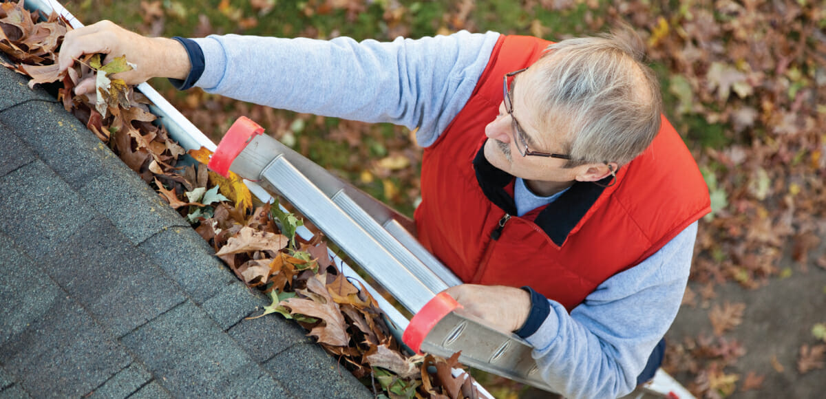 pahlisch homeowner maintenance checklist, man clearing gutter
